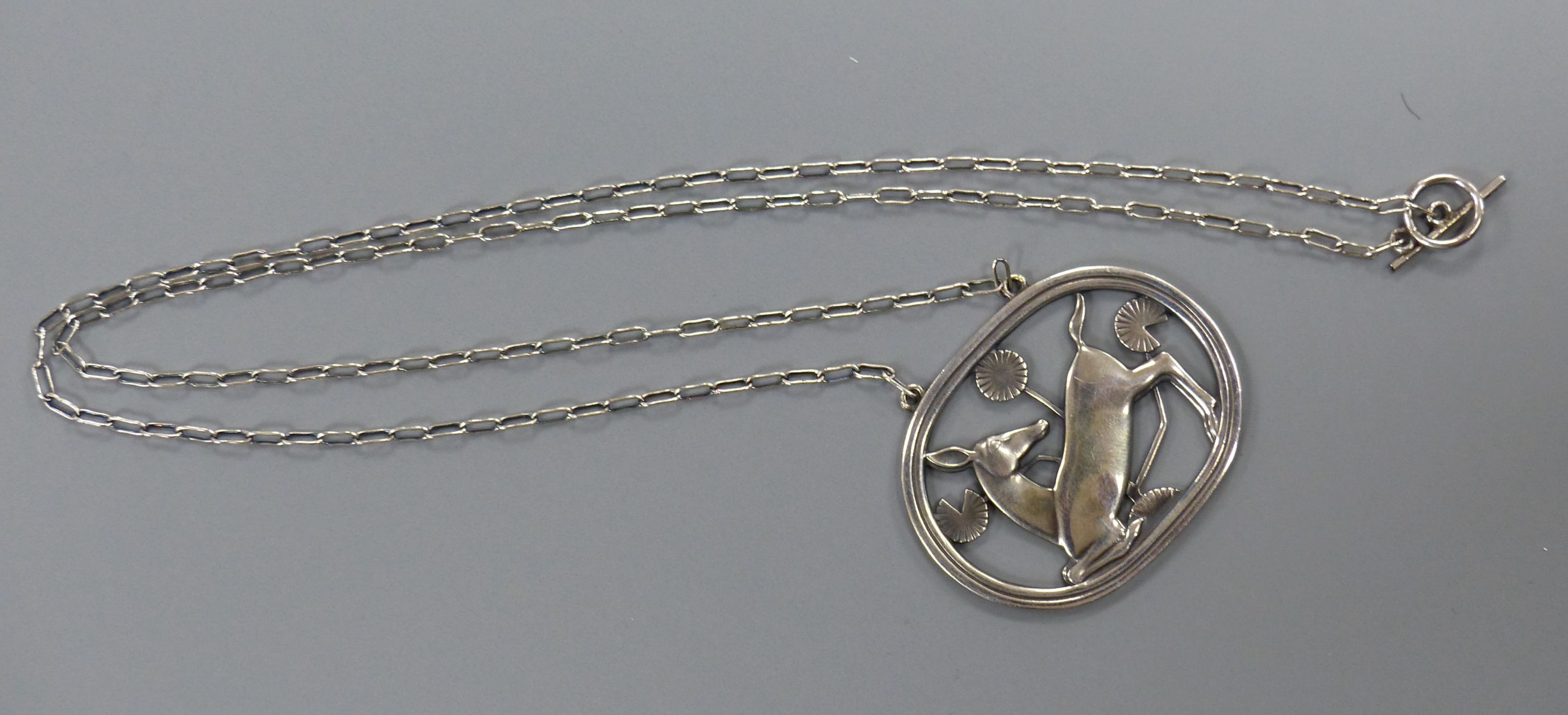 A Georg Jensen sterling oval kneeling deer pendant necklace, no. 95, pendant 42mm, chain, 58cm.